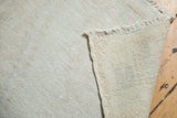 Detail of vintage distressed Oushak rug reverse, with tight foundation, secured fringe, and a pink mark.