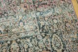 Distressed vintage Khorassan carpet: ornate floral pattern, blush, gold, and navy with textured wear.