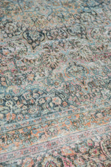 Distressed Khorassan carpet showing intricate floral patterns, dusty blush, teal, and pale gold tones.