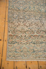 Distressed Malayer runner showing secured side, abrashed field, and faint blue, ivory Herati motif.
