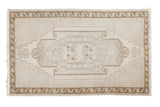 Vintage distressed Oushak rug mat, ivory with pale bronze medallion, seafoam green accents.