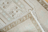 Hand-knotted foundation, original side cord selvage, and distressed pile of vintage Oushak rug.