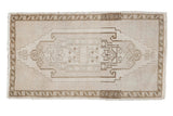 Distressed vintage Oushak rug with muted ivory, pale bronze medallion, and curvilinear details, 1'10
