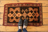 Bold triple geometric design on vintage Turkish Oushak rug mat in brown, tangerine, aubergine.
