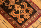 Thick pile vintage Oushak rug with aubergine border and bold tangerine motif.