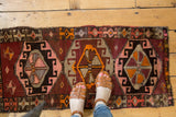 Vintage Oushak runner, showing playful village geometric patterns in aubergine, blush, and orange.