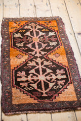 Textured pile of vintage Oushak rug showing tangerine border and germinating plant motif.