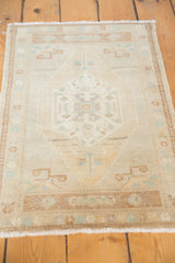 Distressed Oushak rug with time-softened ivory, pale bronze, mint green abrash and serrated steps.
