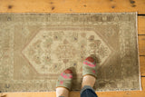 Vintage Oushak rug mat, low pile with muted medallion and blossomed floral motifs in beige, ivory.
