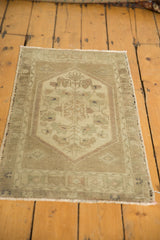 Intricate meandering vine minor border and low pile on the vintage Oushak rug mat.