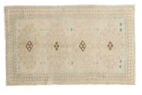 Distressed vintage Oushak rug with ivory, sand, and brown geometric pawn motifs. 1'10