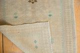 Hand-knotted foundation and intact selvages of a distressed vintage Oushak rug.
