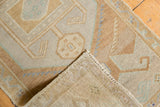 Vintage Oushak rug showing distressed pile, hand-knotted foundation, and intact selvage.