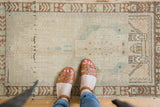 Vintage distressed Oushak rug with soft texture and even wear to knot heads.