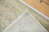 Vintage Oushak rug's hand-knotted foundation, original selvage, and distressed floral pile.