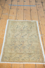 Vintage distressed Oushak rug showing even pile and muted ivory, sand, seafoam pattern.