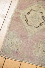 Distressed pale mauve and muted ivory pile with intact selvage and secured end.