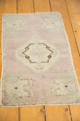 Distressed vintage Oushak rug texture with even wear, pale mauve and ivory hues.