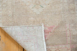Intact side cord selvage and distressed ivory Oushak pile showing evenly worn knot heads.
