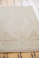 Distressed vintage Oushak rug mat with uniform soft pile and faded stepped medallion design.