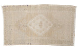 Vintage distressed Oushak rug mat with faded ivory beige medallion, 1'9