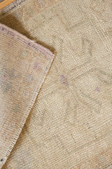 Distressed vintage Oushak rug showing hand-knotted pile and reverse side texture.