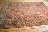 Distressed Heriz carpet border showcasing geometric florals, slate blue, and celadon green.