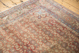 Distressed Bijar corner, low pile Herati motif in soft brick red and blue.