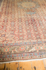 Distressed brick red Herati field and multi-hued traditional border on a vintage Bijar carpet.