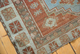 Worn brick red pile, sky blue guls, and geometric border on vintage Afshar rug.