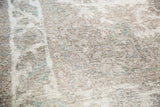 Distressed Sivas carpet pile detail, revealing foundation and muted ivory, gray, teal colors.