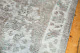 Distressed texture of vintage Sivas carpet with visible foundation, mostly even wear, ivory, gray, and teal.