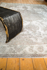 Faded ivory and gray patterns on the distressed vintage Sivas rug with visible foundation.