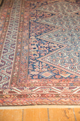 Malayer rug's intricate geometric borders and serrated field patterns in blue and red.