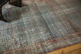 Textured vintage Serbend runner section showing abrashed blues, faded mir boteh, and border.