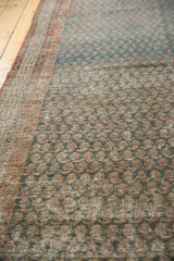 Abrashed blues, sea foam, and brick red mir boteh pattern on a distressed vintage Serbend rug.
