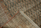 Distressed Serbend rug with visible wear to foundation, faded mir boteh design, and secured edge.