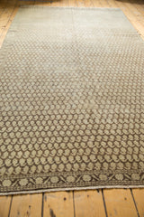 Distressed Mir boteh pattern and banded border of antique Malayer rug, with beige and brown patina.
