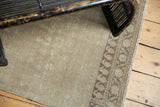 Antique distressed Persian Malayer runner, beige striated pile and stylized brown border.