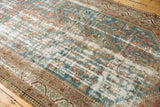 Distressed vintage Malayer rug runner with worn pile, visible foundation, faded blue, red, green, ivory.