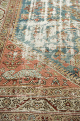 Distressed vintage Malayer rug with a leopard motif in the dusty brick red corner spandrel.