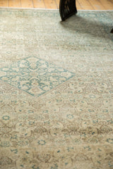 Textured distressed vintage Tabriz rug with faded teal diamond and worn Herati motifs.