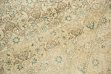 Distressed vintage Tabriz rug detail: Herati pattern, light foundation visible, ivory, sand, teal, brown.