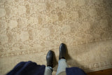 Distressed vintage Tabriz carpet with antique ivory field and brown shadow laurel design.
