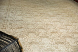 Distressed vintage Tabriz carpet with muted ivory and sand tones revealing allover shadow laurel motifs.