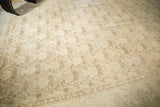 Distressed vintage Persian Tabriz corner with muted shadow laurel pattern and border.
