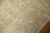 Textured pile of vintage distressed Tabriz carpet with subtle laurel design and mostly even wear.
