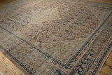 Distressed Mahal carpet corner, showing cobalt blue border, worn Herati field, and foundation.