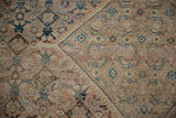 Distressed Mahal carpet pile showing the Herati pattern with apricot, sand, and blue tones.