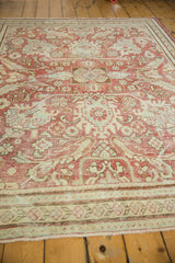 Worn fringe and patterned border of the vintage distressed Mahal carpet.